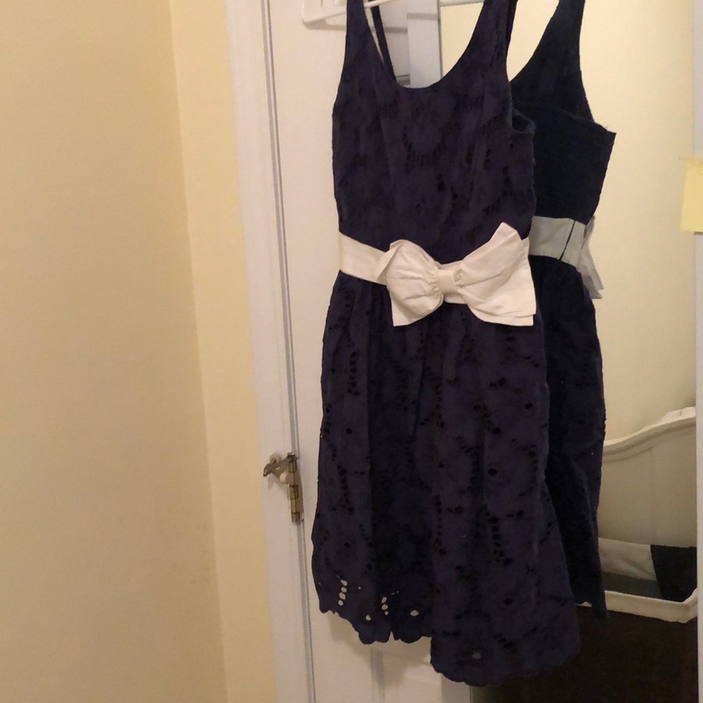 Delia’s navy dress with white ribbon